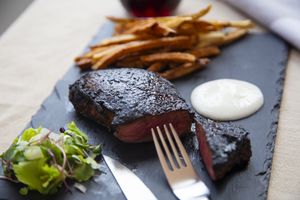 Steak and chips on a slate